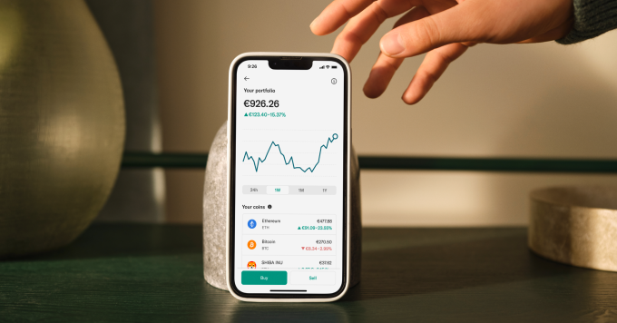 Hand holding a mobile showing the N26 app cryptocurrency portfolio.