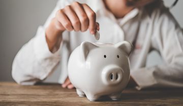 Person filling up his piggy bank.