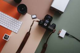 image of a camera, a hard drive and a keyboard.