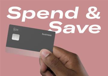 hand holding a N26 business debit card with the words "Spend" and "Save" in the background.