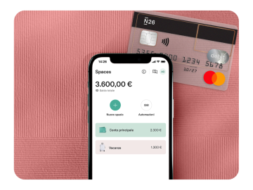 The N26 app displays the balance in Spaces, accompanied by a transparent N26 card against a rhubarb-colored background.