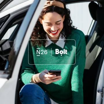 N26 and Bolt logos with the image of a woman sitting on car and looking at her mobile in the background.