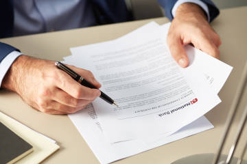 Business man checking a bank contract.