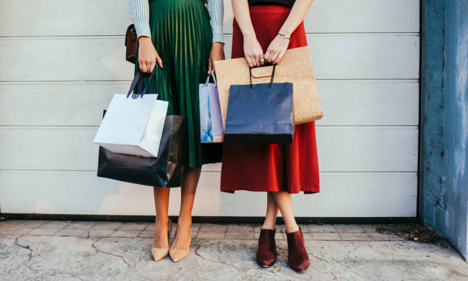 Two women with shopping bags.