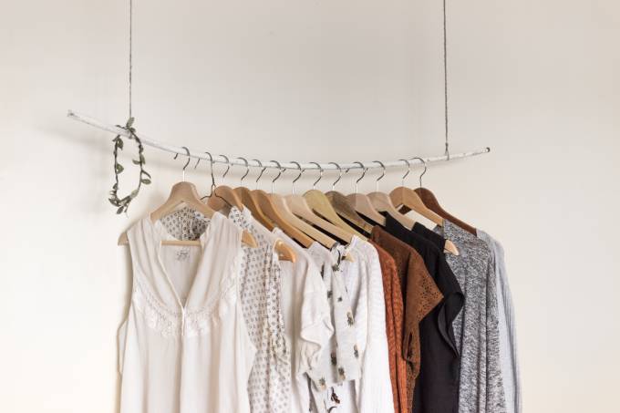 Second hand clothes hanging on hangers.