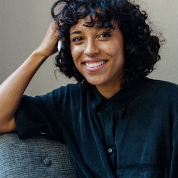 Woman looking in the camera, smiling.