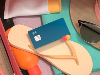 A blue credit card, yellow flip flops, sun screen, and sun glasses.