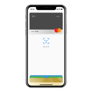 An iPhone X with the Apple Pay screen open on it.