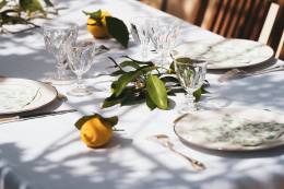 Table with lemons and cutlery.