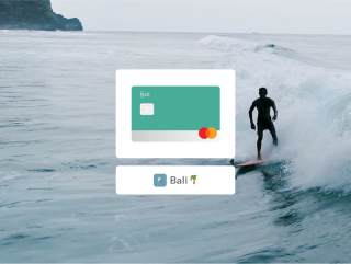 N26 You teal card and the word Bali with a background image of a person surfing. 