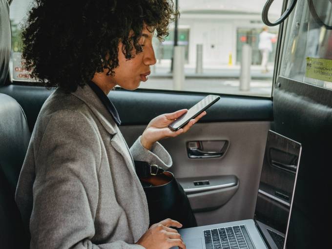 Woman in the car working and negotiating.