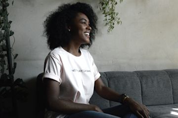 Woman smiling on a couch.