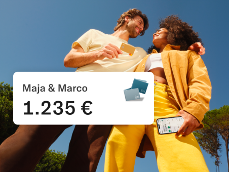 Marco and Maya hugging outdoor. Marco is holding his N26 card and Maja her mobile. In the foreground, there is a pop up showing the joint account balance of 1.235 euros.