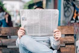 Man reading a newspaper.