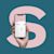Hand holding a smartphone with the letter S in the background.