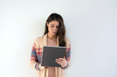 A woman reading on a tablet. 