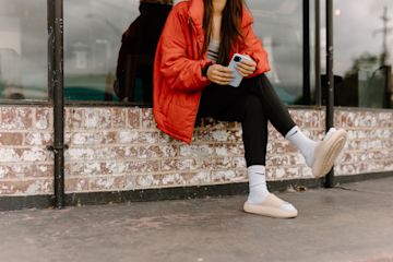 A woman looks at her cell phone.