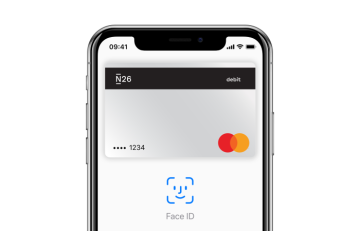 An iPhone X with the Apple Pay screen open on it.