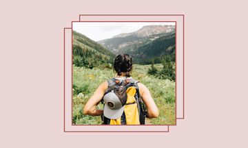 Girl wearing a backpack on a mountain path.