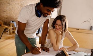 Young man showing partner how the debt snowball method works.