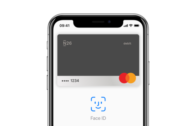 An iPhone X with the Apple Pay screen open on it.