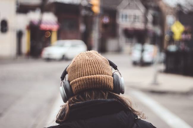 Person walking wearing headphones.