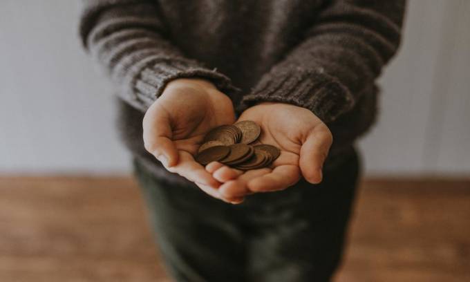 Hands holding some coins.