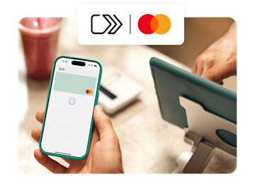 A hand holds a smartphone ready for a contactless payment with an N26 card on screen and a Mastercard icon overlaid.