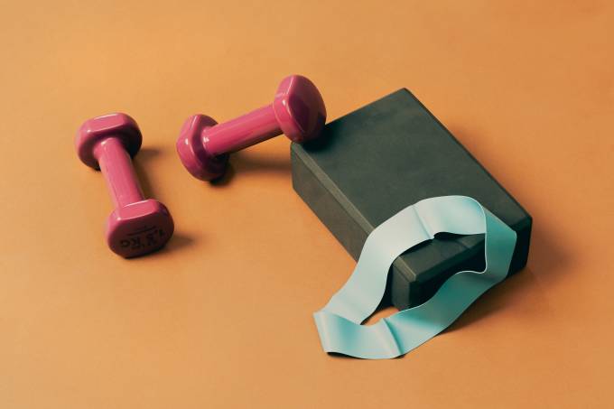 Gym equipment on orange background.