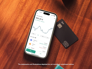 A smartphone shows a cryptocurrency portfolio with balances and a line graph next to a black N26 Mastercard.