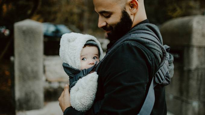Man with beard holding baby.