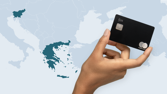 N26 Metal card held by an elevated hand with map of Europe in the background.