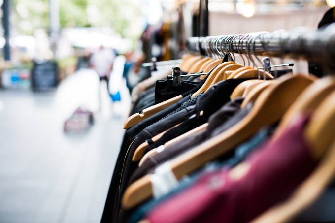 A row of used clothes on sale.