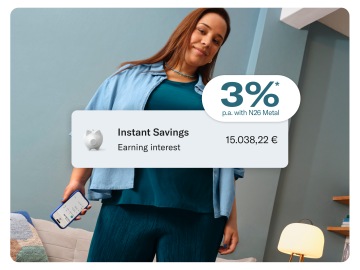 Smiling woman wearing petrol color clothes in a petrol color living room. In the foreground there is pop up showing the balance of the savings account.