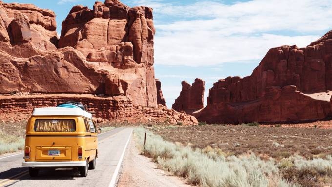 Yellow Volkswagen California van on the desert.