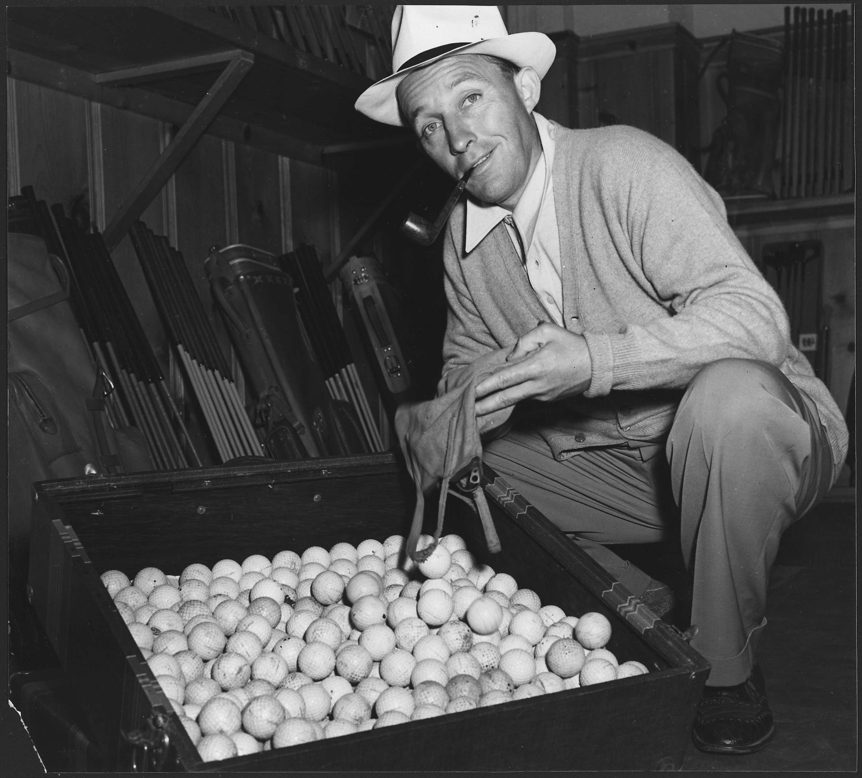 Bing Crosby posing with golf balls collected for the WWII scrap rubber drive, ca. June 1942. Public domain (work of a U.S. federal government employee; FDR Presidential Library / NARA NAID 195573), via Wikimedia Commons: https://commons.wikimedia.org/wiki/File:Bing_Crosby.jpg