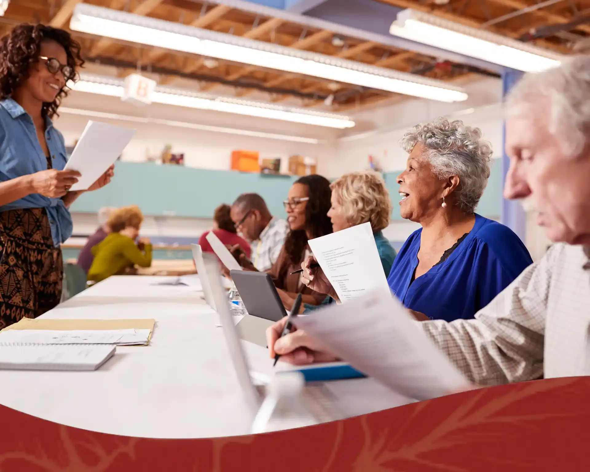 Volunteers reviewing paperwork together at a community table indoors.