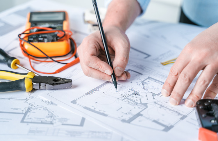 electrician rewiring a house plan