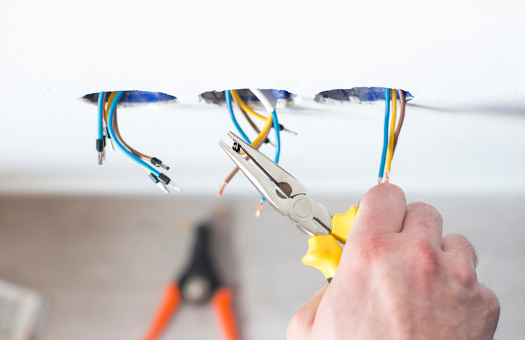 electrician rewiring house sockets 