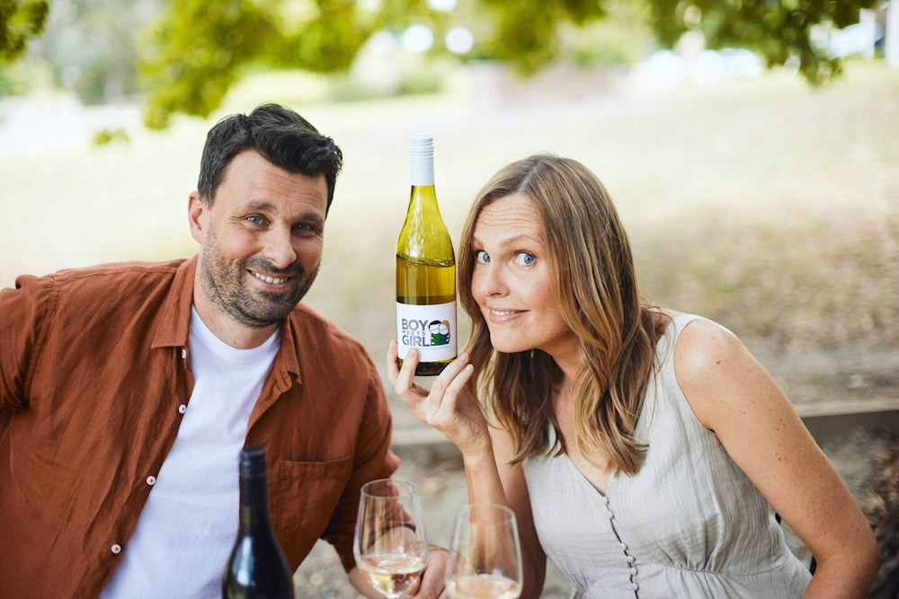 Adrian & Rebecca Santolin proudly showing off the final product after bottling - Boy Meets Girl Pinot Grigio