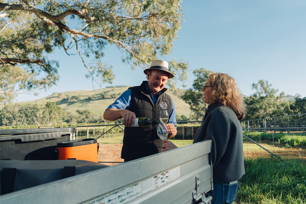 Winemaker Sam Plunkett and wife Bron sharing a glass of wine.