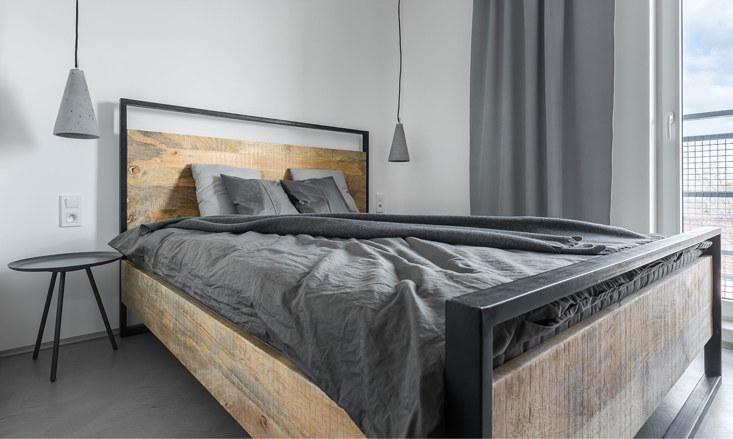 A bedframe composed of rustic wood and metal.
