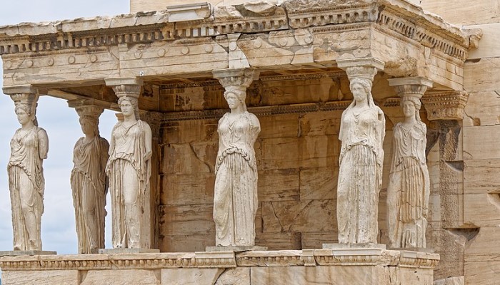 Colour photo of the Erechtheion (an ancient Greek temple in Athens, Greece). It shows the caryatids which are sculpted female figures that support the building.