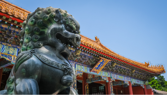 Colour photo of a guardian lion statue in front of the Hall of Supreme Harmony in Beijing, China.