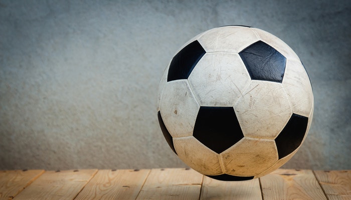 Colour photo of a used black and white soccer ball.