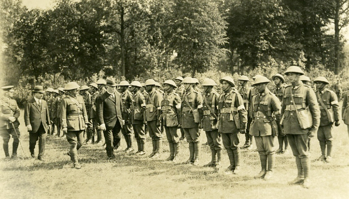 Photo from 1918 showing an inspection of a line-up of uniformed soldiers from the Pioneer (Māori) Battalion in France during WW1.