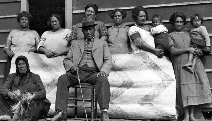 Black and white group photo of Rua Kēnana Hepetipa with some of his household and visitors.
