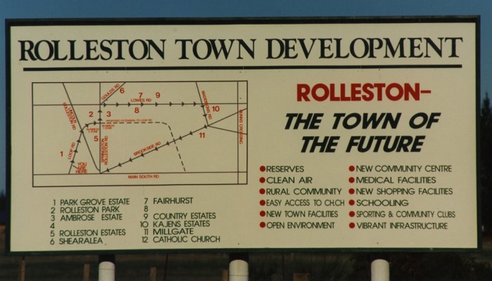 Photo of a sign headed 'Rolleston Town Development'. It has a street map and a list of what the 'Town of the Future' will include.