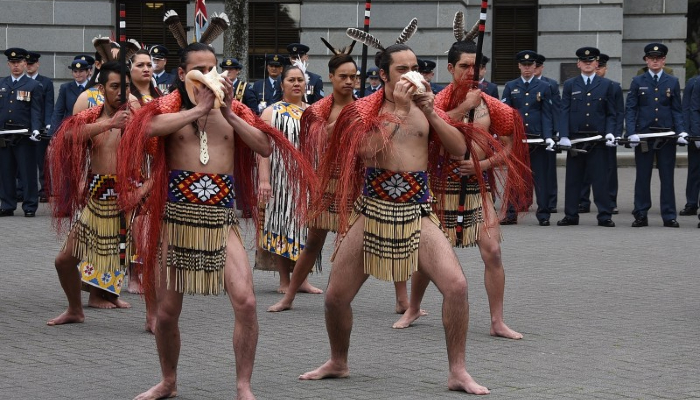Two Māori men blow a pūtātara (shell trumpet) at the swearing-in of the 21st Governor-General of Aotearoa NZ.