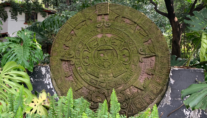 Colour photo of an Aztec sun stone used as a calendar. This one is a replica and is located in the Jesús Reyes Heroles Culture House, Coyoacán, Mexico.